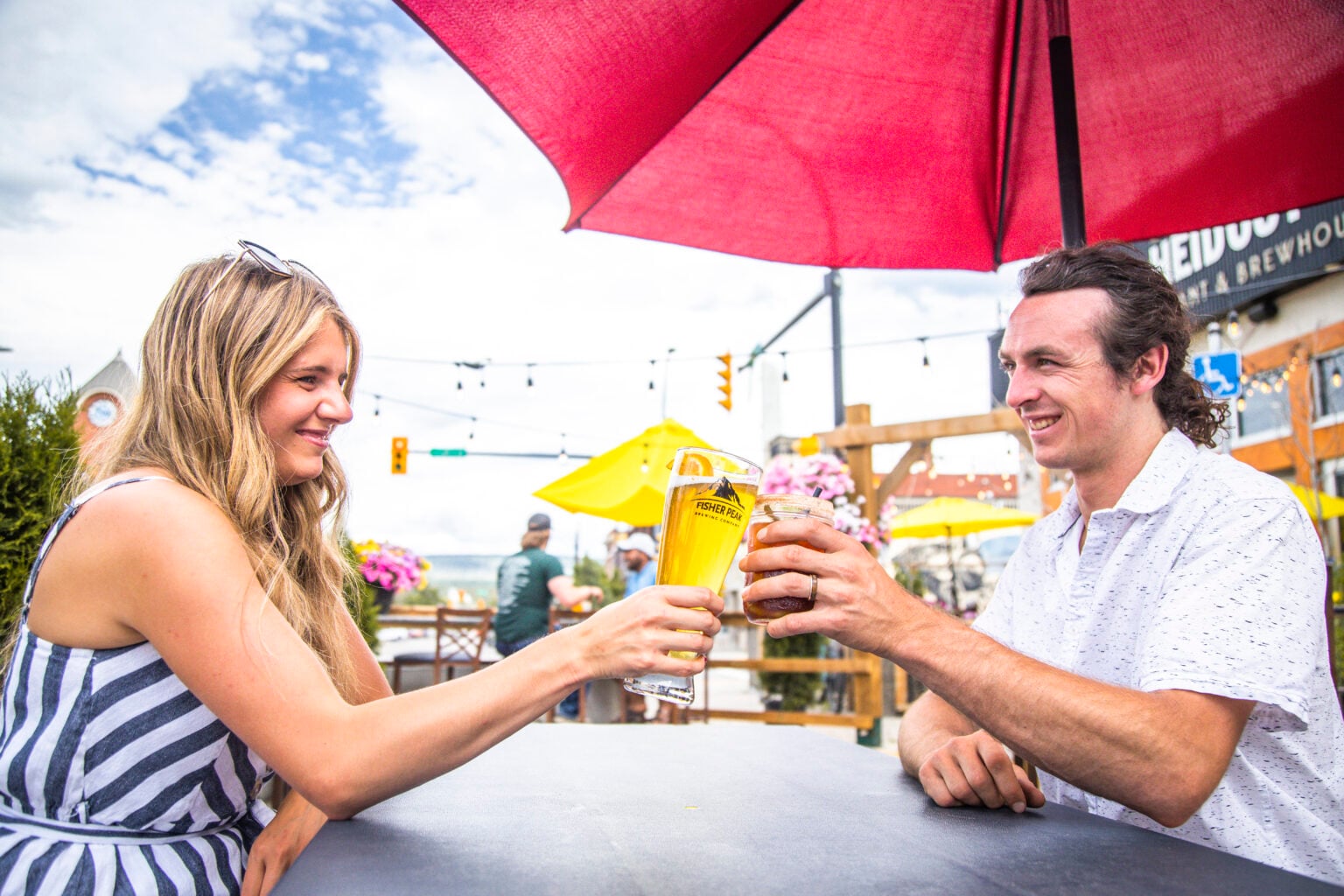 Two people dining on a patio in the summer
